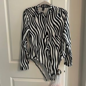 Zebra print zip up long sleeve body suit. Never worn, brand new.